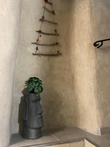 a statue of a head with a christmas tree on a wall at Résidence Mademoiselle Joséphine in Ajaccio