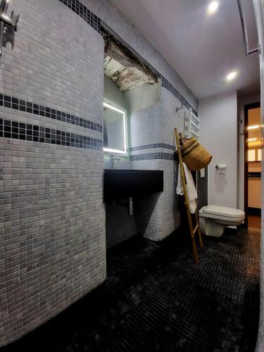 a bathroom with a sink and a toilet at Résidence Mademoiselle Joséphine in Ajaccio