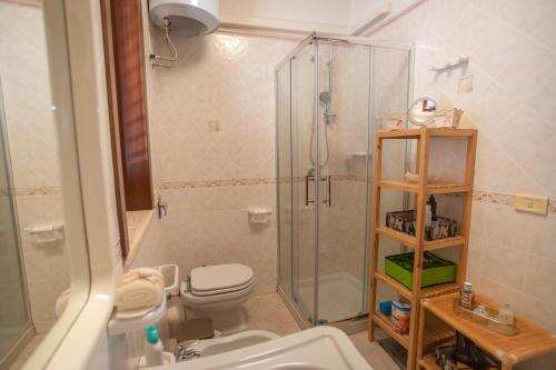 a bathroom with a shower and a toilet and a sink at La Casa di Dani in Lampedusa