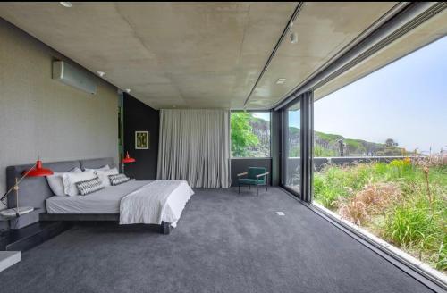 a bedroom with a bed and a large window at Blair Atholl Estate in Lanseria