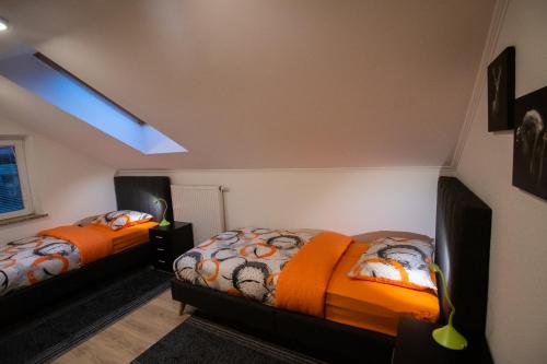 two twin beds in a room with a window at GREEN LAND Family Fun Sport Resort in Šmarje pri Jelšah