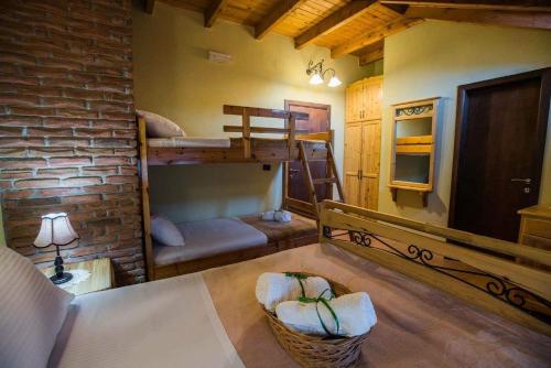 a room with two bunk beds and a brick wall at Vila118 in Voskopojë