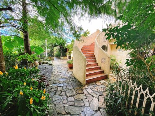 a stairway leading to a house with a stone path at Xin Yuan My Dream Castle in Dongshan