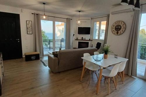 a living room with a couch and a table at Seaview Luxury Apartment with private parking in Mytilini