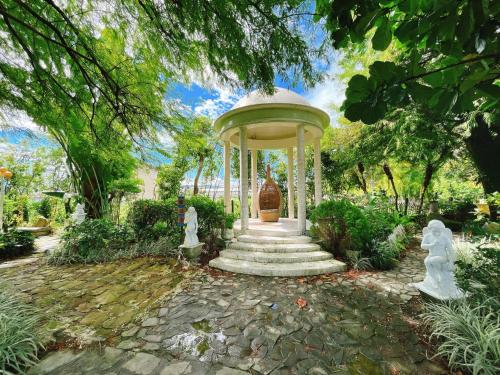 a gazebo in the middle of a garden at Xin Yuan My Dream Castle in Dongshan