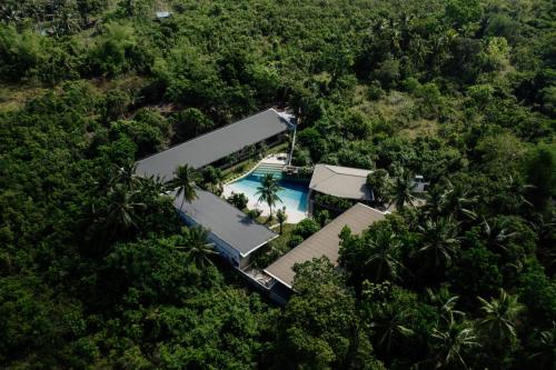 an aerial view of a resort with a pool in the forest at Hidden Lagoon Resort in Panglao Island