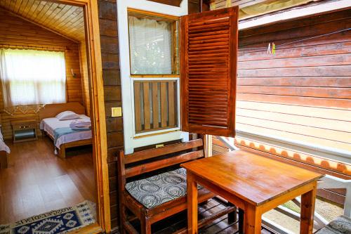 a room with a table and a bench in a cabin at Sunrise Bungalows in Cıralı