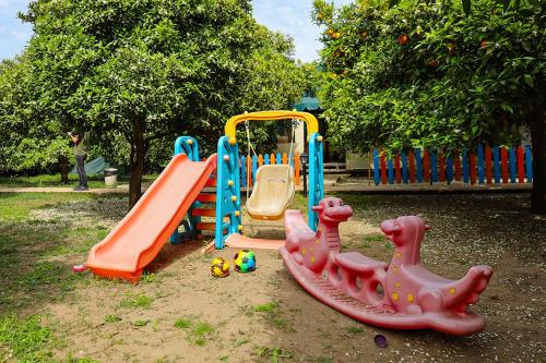 a park with a playground with a play equipment at Sunrise Bungalows in Cıralı
