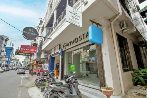 a group of motorcycles parked in front of a store at Vivostay in Medan