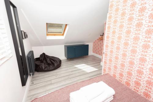 a small room with a bed and a tv at Sunbeam Cottage sleeps 10 in Whitstable