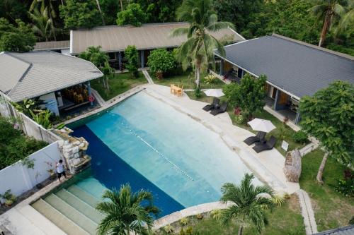 an overhead view of a swimming pool in front of a house at Hidden Lagoon Resort in Panglao Island