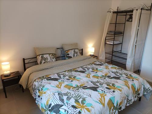a bedroom with a bed with a colorful comforter at O'Couvent - Appartement 66 m2 - 2 chambres - A523 in Salins-les-Bains