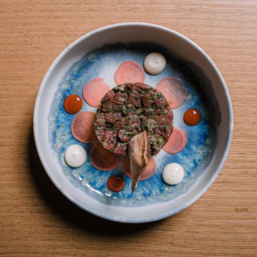 a bowl of food with meat and eggs on a table at 3 Sixty Hotel & Suites in Nafplio
