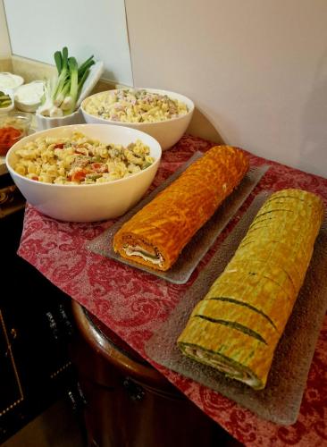 a table with bread and a bowl of rice and a salad at Arbia Dorka Heritage Palace in Varaždin