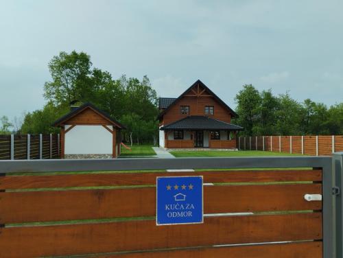 a sign on a fence in front of a house at Holiday home Marta in nature with jacuzzi in Gospić