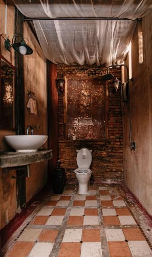 a bathroom with a toilet and a sink at Thai Authentic House in Jomtien Beach