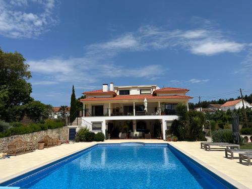 a large house with a swimming pool in front of it at Quinta da Sobreira in Salir de Matos