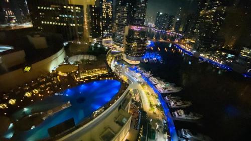 an aerial view of a city at night with boats at The Address Dubai Marina in Dubai