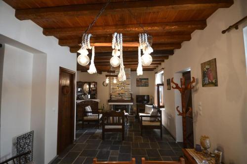 a hallway with a dining room and a living room at Two-storey house with loft at Agria,Volos in Agria