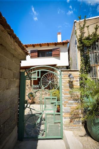a green door with a chair inside of a building at Two-storey house with loft at Agria,Volos in Agria