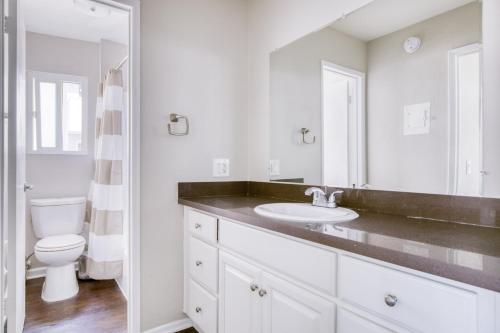 a white bathroom with a sink and a toilet at Westwood 1BR w Rooftop nr Westwood Village LAX-111 in Los Angeles