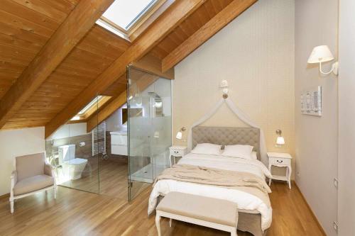 a bedroom with a large bed and a glass wall at Refugio del Roble by BeValle in Panticosa
