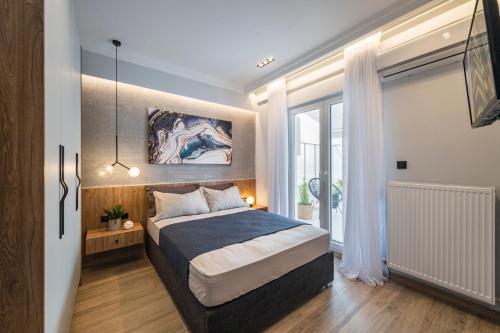 a bedroom with a bed and a large window at ARES penthouse in Thessaloniki