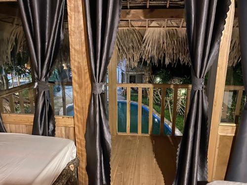 a room with a bed and a view of a pool at MAI HICH FARMSTAY 2 in Mai Hạ