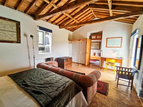 a bedroom with a bed and a living room at Casa da Emilie in Santa Cruz da Graciosa