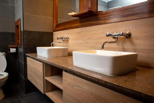 a bathroom with two sinks on a counter at MERCURE HOTEL in Antananarivo