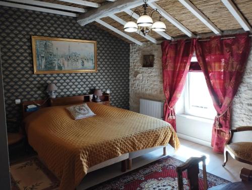 a bedroom with a bed and a window at Chez Marek et Urszula in Le Langon