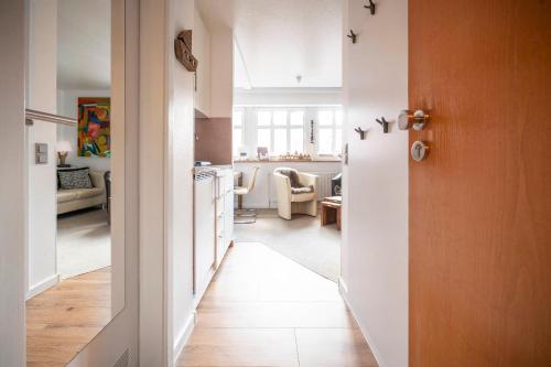 a hallway leading to a kitchen and a living room at Inselresidenz Strandburg - Ferienwohnung 210 (Ref. 50967u2) in Juist
