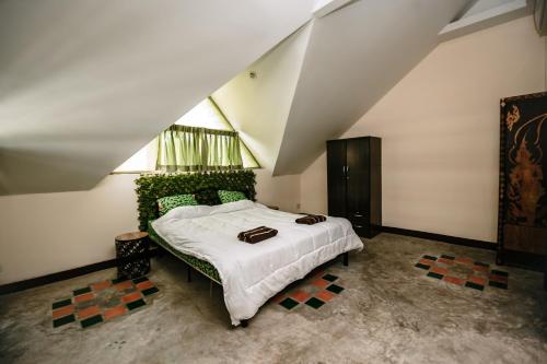 a bedroom with a large bed in a attic at Thai Authentic House in Jomtien Beach