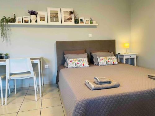 a bedroom with a bed and a table and a chair at New, Modern and Cozy apartment in Gavrio in Gavrion