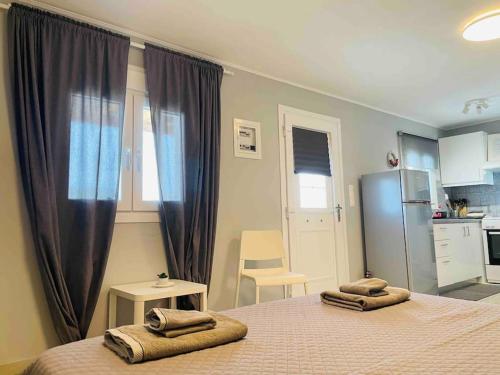 a bedroom with a bed with two towels on it at New, Modern and Cozy apartment in Gavrio in Gavrion