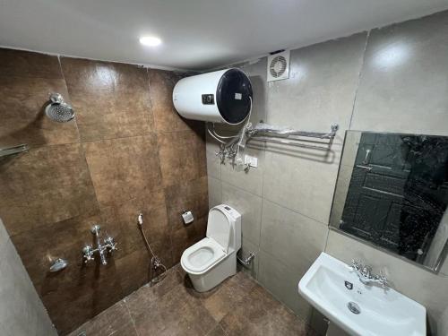 a bathroom with a toilet and a sink at Farmhouse - A Luxury Living in Srinagar