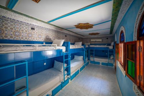 a room with blue bunk beds in it at Riad Verus in Fès