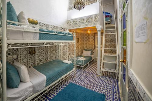 a room with several bunk beds in a room at Riad Verus in Fès