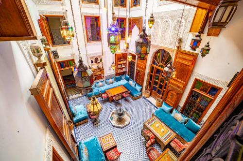 an overhead view of a living room with blue furniture at Riad Verus in Fès