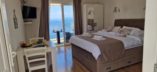 a bedroom with a bed with a view of the ocean at Apartmani Luan in Vis