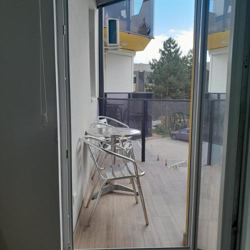 a chair sitting on the balcony of a house at Spa Koncept-Apartmani in Veliko Gradište