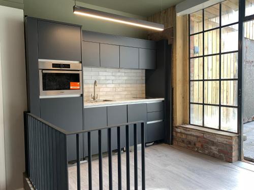 a kitchen with a sink and a stove top oven at Clanbrassill loft in Dundalk