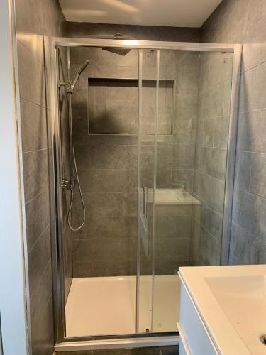 a shower with a glass door in a bathroom at Clanbrassill loft in Dundalk