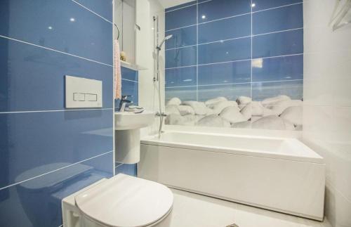 a bathroom with a toilet and a tub and a sink at Тorino luxury с гараж in Sofia