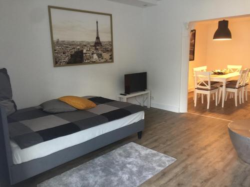 a bedroom with a bed and a dining room with a table at City Appartment Krefeld - 20 km DUS Airport/Messe in Krefeld