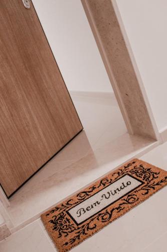 a rug on the floor next to a mirror at Gold Apartment Baleal in Ferrel
