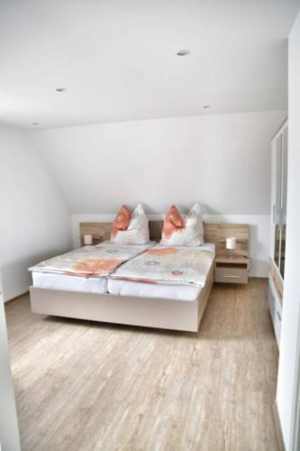 a bedroom with a bed with two pillows on it at Haffmuschel in Ueckermünde