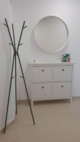 a room with a dresser and a large mirror at Gold Apartment Baleal in Ferrel