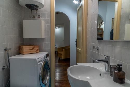 a bathroom with a washing machine and a sink at La Prua in Rovinj