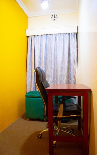 a room with a desk and a chair and a window at One Bedroom House in Langata in Nairobi